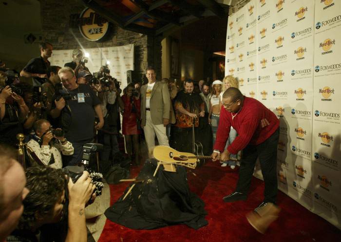 MASHANTUCKET, CT - AUGUST 19:  Mashantucket Pequot Tribal Nation chairman Michael Thomas breaks a guitar at the grand opening of the Hard Rock Cafe at the Foxwoods Resort Casino August 19, 2004 in Mashantucket, Connecticut.  (Photo by Bob Falcetti/Getty Images)
