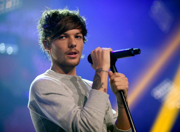 BURBANK, CA - NOVEMBER 22:  Musician Louis Tomlinson performs onstage at the "One Direction iHeartRadio Album Release Party" hosted by Ryan Seacrest at the iHeartRadio Theater Los Angeles  Clear Channel's new music and events venue located at The Burbank Studios in Burbank, CA  (Photo by Christopher Polk/Getty Images for Clear Channel)