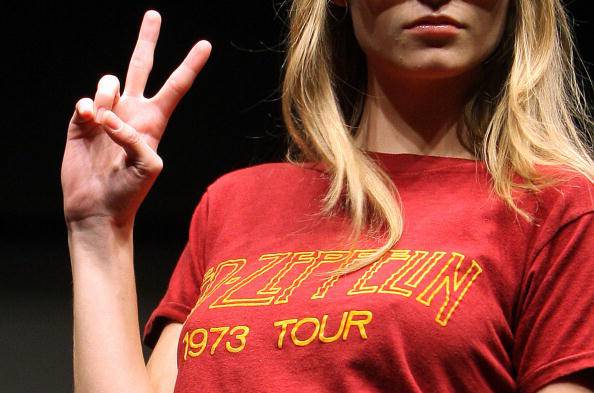 A model displays a vintage Led Zepellin 1973 tour T-shirt (estimated at 1,000-1,500 USD) during a show featuring Rock and Pop memorabilia at Christie's auction house in New York, 16 November 2007. Christie's will hold an auction of 292 lots of Rock and Pop Memorabilia on 30 November 2007, ranging from vintage T-shirts, authographed pictures, original music scores to musical instruments and Gold and Platinum albums. AFP PHOTO/Emmanuel DUNAND (Photo credit should read EMMANUEL DUNAND/AFP/Getty Images)
