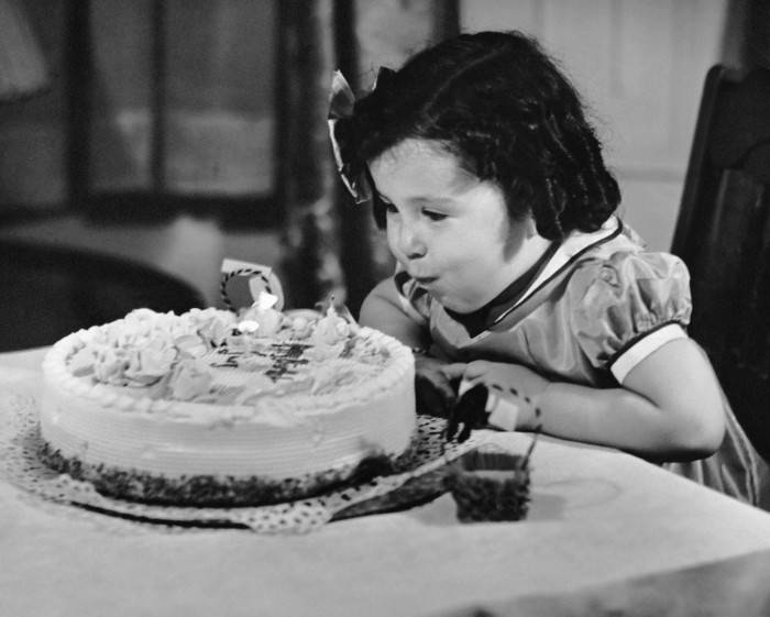 UNITED STATES - CIRCA 1950s:  Young girl blowing out candles on cake.  (Photo by George Marks/Retrofile/Getty Images)