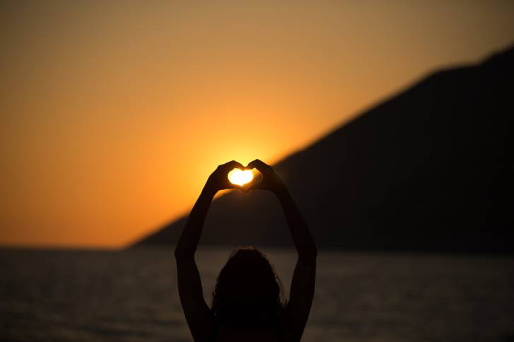 Vacation vitality healthy living concept.Silhouette hand in heart shape