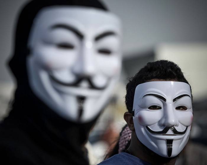 Bahraini protesters wearing Guy Fawkes masks used by the Anonymous movement take part in a demonstration against the government and in solidarity with jailed freelance photographer Ahmed Humaidan in the village of Karranah, west of Manama, on March 1, 2013. Humaidan was arrested during a rally on December 29, 2012 and was charged with "demonstrating illegally" and "using violence to assault police and damage public properties". AFP PHOTO/MOHAMMED AL-SHAIKH        (Photo credit should read MOHAMMED AL-SHAIKH/AFP/Getty Images)