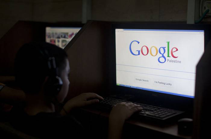 A Palestinian boy opens the Palestinian homepage of Google's search engine reading "Palestine" at an internet cafe in east Jerusalem on May 3, 2013. Internet giant Google has recognised the Palestinians' upgraded UN status, placing the name "Palestine" on its search engine instead of "Palestinian Territories," the US company said, raising the ire of Israel. AFP PHOTO/AHMAD GHARABLI        (Photo credit should read AHMAD GHARABLI/AFP/Getty Images)