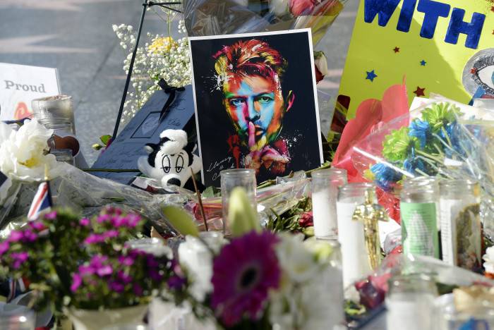 HOLLYWOOD, CA - JANUARY 12:  Candles, flowers and personal notes are placed as a memorial to musician David Bowie on his Hollywood Walk of Fame star on January 12, 2016, in Hollywood, California. (Photo by Kevork Djansezian/Getty Images)