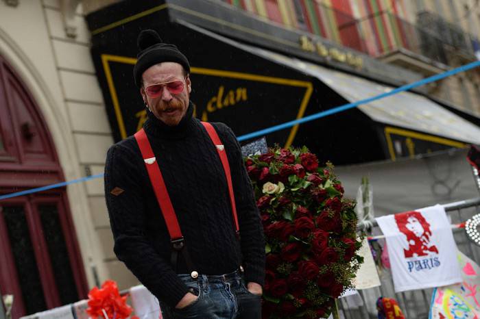 Singer of the US rock group Eagles of Death metal Jesse Hughes pays tribute to the victims of the November 13 Paris terrorist attacks at a makeshift memorial in front of the Bataclan concert hall on December 8, 2015 in Paris.  The Eagles of Death Metal band returned to the Bataclan concert hall in Paris, nearly a month after they survived a jihadist attack there in which 90 people died. / AFP / MIGUEL MEDINA        (Photo credit should read MIGUEL MEDINA/AFP/Getty Images)