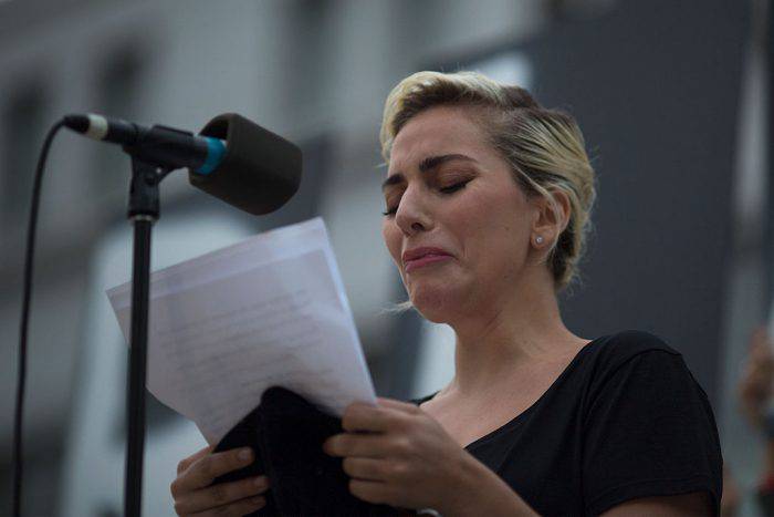 LOS ANGELES, CA - JUNE 13: Singer Lady Gaga tries not to cry while reading some of the names of the dead at a vigil for the worst mass shooing in United States history on June 13, 2016 in Los Angeles, United States. A gunman killed 49 people and wounded 53 others at a gay nightclub in Orlando, Florida early yesterday morning before suspect Omar Mateen also died on-scene.  (Photo by David McNew/Getty Images)