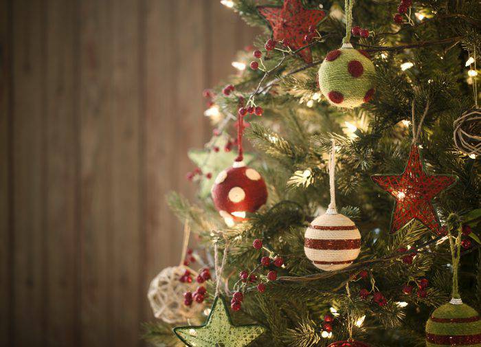Christmas Eco friendly holiday tree with baubles and natural ornaments against a rustic, vintage, old wood background.